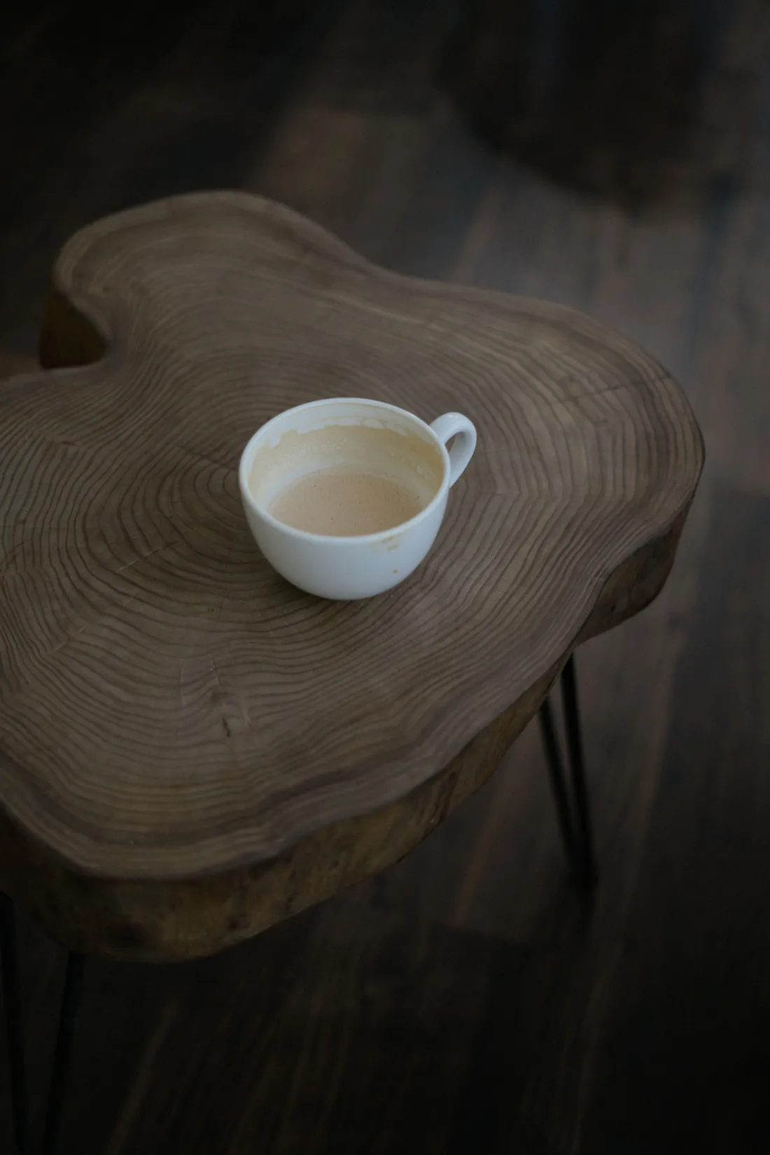A teacup resting on a live-edge wooden table