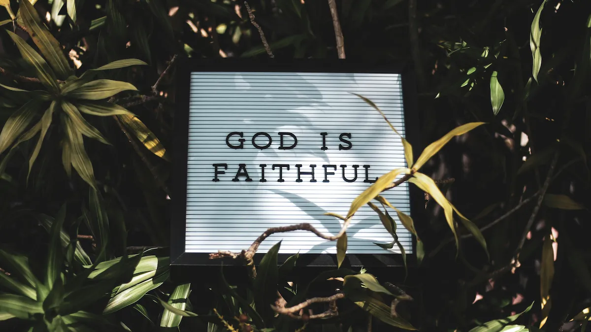 A wooden sign reading God is faithful